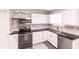 Well-equipped kitchen featuring white cabinets, stainless steel appliances, and dark countertops with wood floors at 104 Shoreland Dr, Osprey, FL 34229