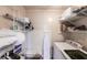 Functional laundry room with shelving for storage and modern washer and dryer units at 104 Shoreland Dr, Osprey, FL 34229