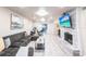 Spacious living room featuring a stone fireplace, plush sectional sofa, and sliding glass doors at 104 Shoreland Dr, Osprey, FL 34229