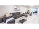 Comfortable living room featuring a large sectional sofa, modern coffee table, and light colored floors at 104 Shoreland Dr, Osprey, FL 34229