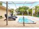 Relaxing screened-in pool area with lounge chairs at 104 Shoreland Dr, Osprey, FL 34229