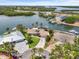 Aerial view of waterfront property with lush landscaping, private dock, and stunning river vistas at 10432 Sandpiper W Rd, Bradenton, FL 34209