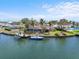 Waterfront property with private dock, boat, palm trees and screened-in pool, perfect for enjoying the coastal lifestyle at 10432 Sandpiper W Rd, Bradenton, FL 34209