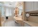Bright bathroom featuring tile flooring, block glass, and a vanity with ample counter space at 10432 Sandpiper W Rd, Bradenton, FL 34209
