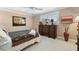 Cozy bedroom featuring neutral tones, a large window, and classic wood furniture at 10432 Sandpiper W Rd, Bradenton, FL 34209