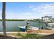 Waterfront dock with a boat, perfect for enjoying waterfront living and boating activities at 10432 Sandpiper W Rd, Bradenton, FL 34209