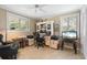 Well-lit home office featuring a large desk with dual monitors and comfortable seating at 10432 Sandpiper W Rd, Bradenton, FL 34209