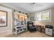 Cozy home office featuring a bookcase with accent lighting, a window, and a comfortable chair at 10432 Sandpiper W Rd, Bradenton, FL 34209