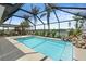 Sparkling pool inside screened enclosure with waterfront view and lush landscaping at 10432 Sandpiper W Rd, Bradenton, FL 34209