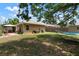 Spacious backyard with a covered patio, lush green grass, and a hammock at 1052 32Nd St, Sarasota, FL 34234