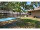 This backyard features a hammock under a tree and a seating area for outdoor relaxation and entertaining at 1052 32Nd St, Sarasota, FL 34234