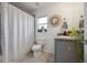Well-lit bathroom with a decorative mirror, shower with tub, and tiled floor at 1052 32Nd St, Sarasota, FL 34234