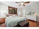 Bedroom featuring hardwood floors, dresser, nightstand, ceiling fan and ensuite bathroom at 1052 32Nd St, Sarasota, FL 34234