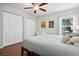 Bedroom featuring hardwood floors, ceiling fan, and large closet at 1052 32Nd St, Sarasota, FL 34234