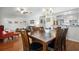 Open concept dining room features a ceiling fan, hardwood floors and is adjacent to the kitchen and living area at 1052 32Nd St, Sarasota, FL 34234