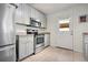 White kitchen features stainless steel appliances, tile floors and a back door at 1052 32Nd St, Sarasota, FL 34234