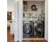 Functional laundry room with washer, dryer, and shelving for storage at 1052 32Nd St, Sarasota, FL 34234