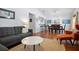 Open-concept living room with view to dining room, hardwood floors, and contemporary furnishings at 1052 32Nd St, Sarasota, FL 34234