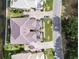 Aerial view of the home featuring a tile roof, landscaping, and paver driveway near the lagoon at 1109 Riverscape St, Bradenton, FL 34208