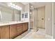 Bright bathroom with double vanity, granite countertops and corner glass shower at 1109 Riverscape St, Bradenton, FL 34208
