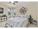 Sunlit bedroom featuring a cozy bed, a ceiling fan, and large windows at 1109 Riverscape St, Bradenton, FL 34208
