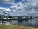Community boat dock featuring multiple boat slips, beautiful water views, and blue skies at 1109 Riverscape St, Bradenton, FL 34208