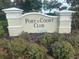 Port & Court Club entrance sign surrounded by landscaped flowerbeds at 1109 Riverscape St, Bradenton, FL 34208