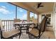 The screened lanai features a round dining table with seating, ceiling fan, and views of the water at 1109 Riverscape St, Bradenton, FL 34208