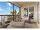 The screened lanai features outdoor sofa and chairs, plus sliding glass doors to inside, and water views at 1109 Riverscape St, Bradenton, FL 34208