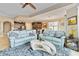 Open-concept living area featuring blue sofas, modern decor, and seamless access to the adjacent kitchen at 1109 Riverscape St, Bradenton, FL 34208