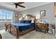 This main bedroom features a beautiful wood bed frame, bedside tables, and a window offering scenic views at 1109 Riverscape St, Bradenton, FL 34208