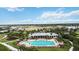 Community pool featuring a spacious deck, lounge chairs, and lush landscaping overlooking the bay at 1109 Riverscape St, Bradenton, FL 34208