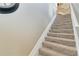 Carpeted staircase with white railing and neutral walls at 1109 Riverscape St, Bradenton, FL 34208