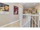 Upstairs hallway featuring tile flooring and a view of the staircase and archways at 1109 Riverscape St, Bradenton, FL 34208