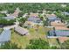 Aerial view of a home with a large backyard, a pool, and lush greenery in a residential neighborhood at 11236 Beebalm Cir, Lakewood Ranch, FL 34202
