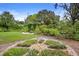 Community garden with beautiful brick pathways, lush vegetation and seating areas at 11236 Beebalm Cir, Lakewood Ranch, FL 34202