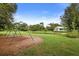 Community park featuring a pond and home in the background, with a swing set to the left at 11236 Beebalm Cir, Lakewood Ranch, FL 34202