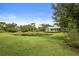 Community park featuring a pond and home in the background, with greenery in the foreground at 11236 Beebalm Cir, Lakewood Ranch, FL 34202