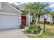 Charming home featuring well-manicured landscaping and a welcoming red door at 11236 Beebalm Cir, Lakewood Ranch, FL 34202
