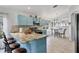 Bright kitchen boasts custom blue cabinetry, granite counters, and stainless steel appliances at 11236 Beebalm Cir, Lakewood Ranch, FL 34202