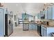 Bright, open kitchen with blue cabinetry, stainless steel appliances, and a view to the backyard at 11236 Beebalm Cir, Lakewood Ranch, FL 34202