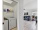 Functional laundry room with modern washer and dryer, adjacent to living space at 11236 Beebalm Cir, Lakewood Ranch, FL 34202