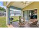 Charming covered patio with grill, seating area, and view of yard at 11236 Beebalm Cir, Lakewood Ranch, FL 34202