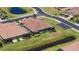Scenic aerial view of residential homes, manicured lawns, and neighborhood pond at 1203 Calle Grand St, Bradenton, FL 34209