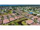 Aerial view of a residential neighborhood with a pond, lush landscaping, and well-maintained streets at 1203 Calle Grand St, Bradenton, FL 34209