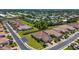 Aerial view of a residential neighborhood with a pond, lush landscaping, and well-maintained streets at 1203 Calle Grand St, Bradenton, FL 34209