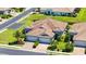 Aerial view showcasing the home's tiled roof, landscaping, and three-car garage at 1203 Calle Grand St, Bradenton, FL 34209