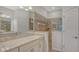 Well-lit bathroom with dual sinks, granite counters, and a beautifully tiled walk-in shower at 1203 Calle Grand St, Bradenton, FL 34209