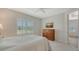 Inviting bedroom with a comfortable bed, wooden dresser, and window with shutter blinds offering natural light at 1203 Calle Grand St, Bradenton, FL 34209