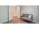 Cozy bedroom with stylish gray sofa, neutral paint, and bright natural light at 1203 Calle Grand St, Bradenton, FL 34209